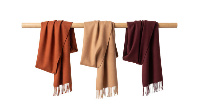 Cashmere wool scarves in autumn colors, elegant pashmina shawls on wooden rack, luxury winter fashion accessories