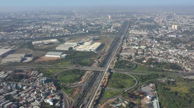 Aerial drone view of Tram 2 Interchange in Tang Nhon Phu Ward, Ho Chi Minh City, Vietnam, showing busy traffic at the intersection of National Highway 1A and the Eastern Ring Road.