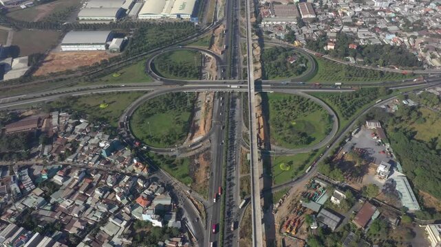 Aerial drone view of Tram 2 Interchange in Tang Nhon Phu Ward, Ho Chi Minh City, Vietnam, showing busy traffic at the intersection of National Highway 1A and the Eastern Ring Road.