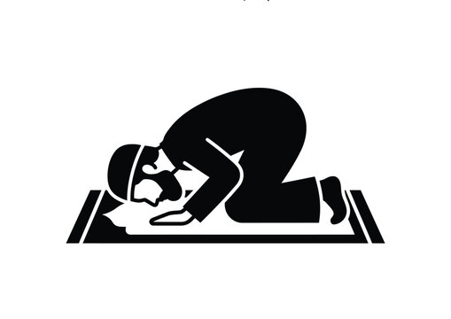 Islamic man praying on a prayer mat in silhouette.