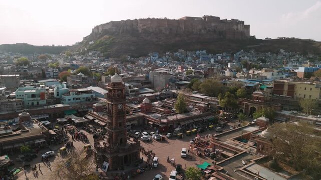 Aerial view of sardar market clock tower with mehrangarh fort in jodhpur, india, the blue city