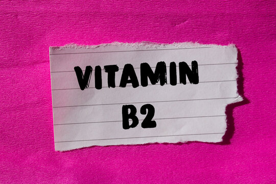 Vitamin B2 message written on ripped torn paper background. Conceptual Vitamin B2 symbol. Copy space.