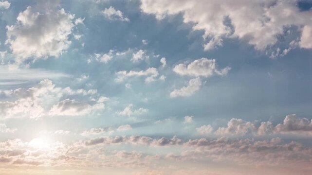 Scenic blue sky with fluffy white clouds and soft morning sunlight shining through