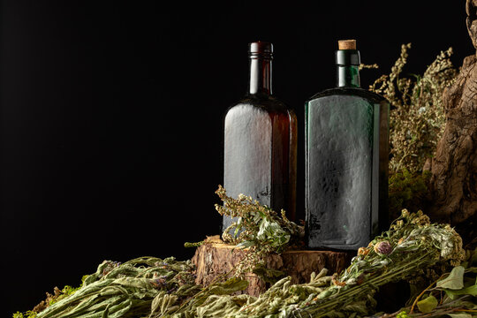Vintage bottles with tinctures and various dried herbs.