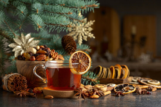 Tea with spices and dry fruits on a kitchen table.
