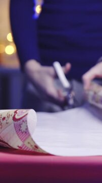 Cutting gift paper for christmas present