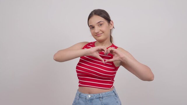 Indian Teenage Girl  Making Heart with Hands and Smiling