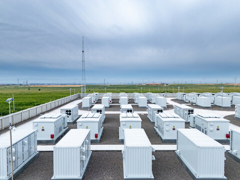 rows of white energy storage containers in outdoor field