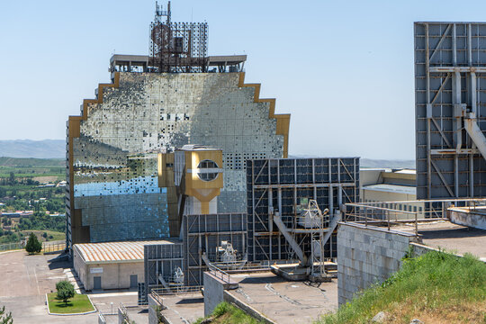 Big Solar Furnace in Uzbekistan. Large solar power facility with reflective panels and industrial structures under clear sky