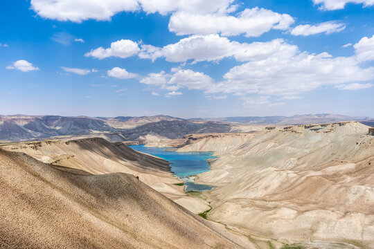 Band-e-Amir blue natural lake in Bamyan Province, Afghanistan. Arid mountain valley with turquoise lake under blue sky with white clouds