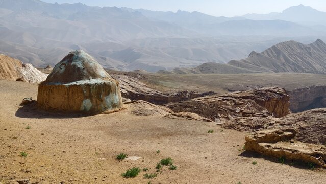 Dragon Valley in Bamyan province in Afghanistan. Desert dome structure with mountainous backdrop under clear sky