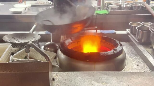 Hands Cooking Noodles and Vegetables in Wok &ndash; Chinese Restaurant Kitchen