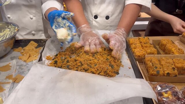 Chef Hands Making Traditional Chinese Flaky Pastry Squares with Sweet Filling and Crispy Coating &ndash; Handcrafted Bakery Preparation in Supermarket