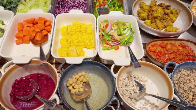 Assorted Prepared Ingredients on Salad Bar Counter &ndash; Fresh Vegetables, Dressings and Toppings for Custom Meals