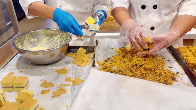 Chef Hands Making Traditional Chinese Flaky Pastry Squares with Sweet Filling and Crispy Coating &ndash; Handcrafted Bakery Preparation in Supermarket