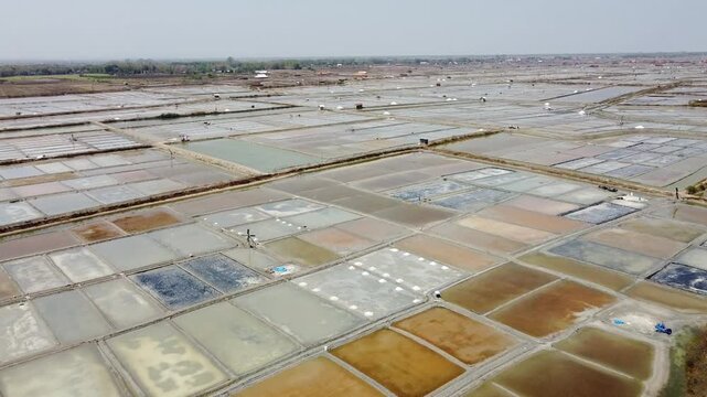 Salt farming, harvesting the white gold. Beautiful salt pans of Rembang, Indonesia.