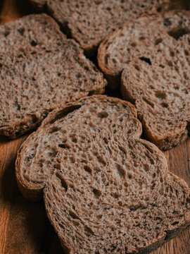 Four Wholegrain Bread Slices Arranged in Cross Pattern, Top-Down Crumb Texture Detail