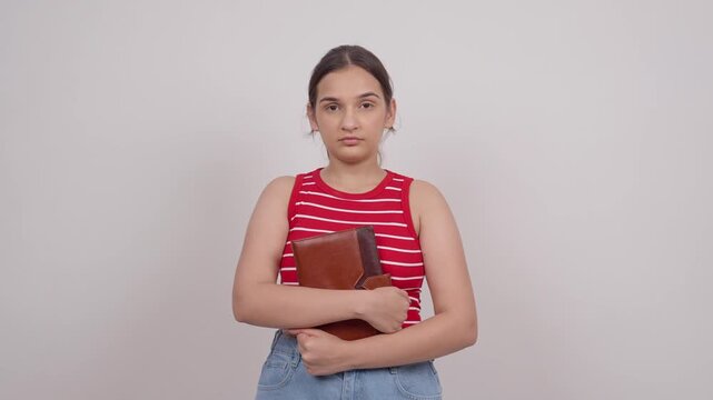 Confident Indian Teenage Girl Standing with Notebook