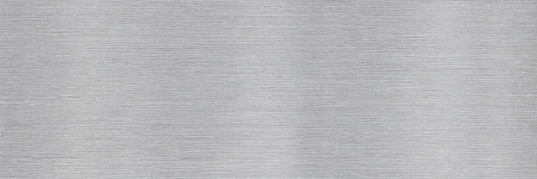 Brushed stainless steel texture, metallic silver background. Sleek brushed aluminum finish pattern, smooth shiny surface mockup for industrial design and technology backgrounds.