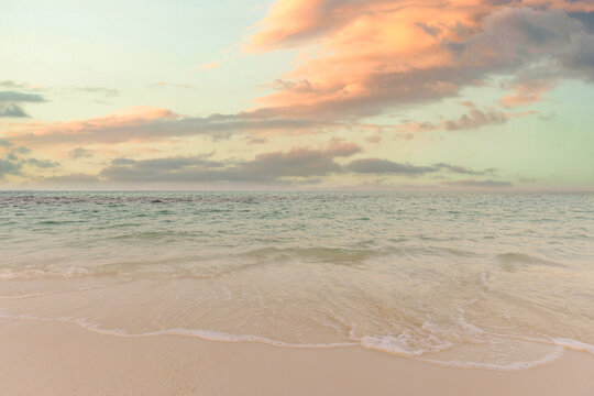 Tranquil pastel sunset calm sea soft glowing sky tropical beach shore evening light gentle ocean water. Peaceful summer nature seascape meditation wellbeing. Relaxing coastal inspiring wallpaper scene