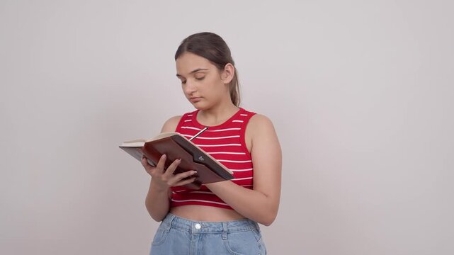 Indian Teenage Girl Writing in Notebook