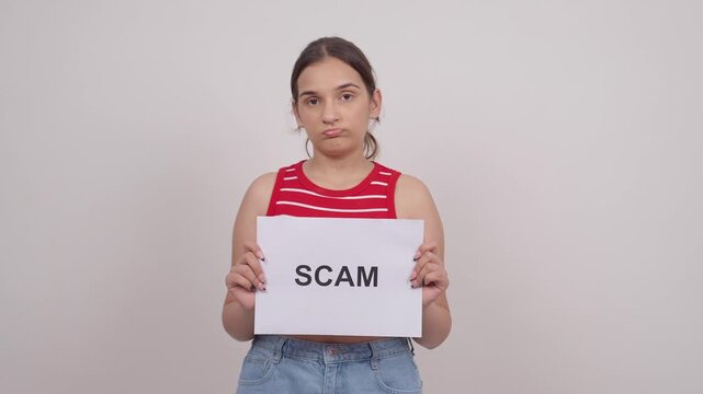 Sad Indian Teenage Girl Holding SCAM Poster