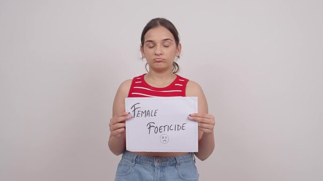 Sad Indian Teenage Girl Holding Female Foeticide Poster