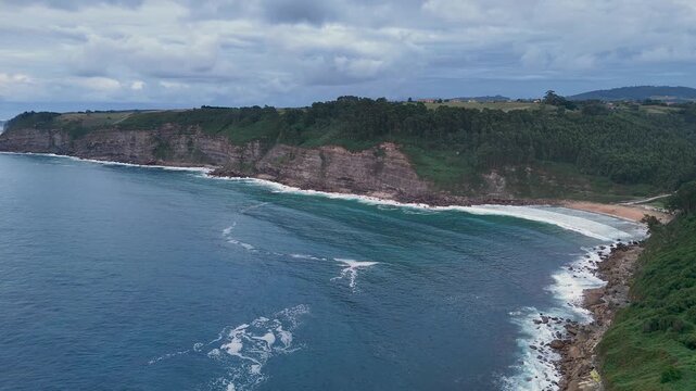 Aerial view of a secluded beach and cliffs on the Asturias coast