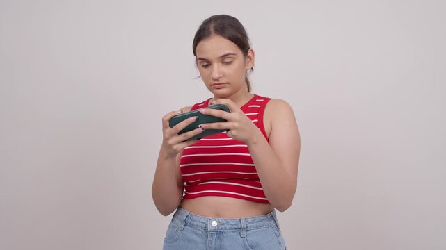 Indian Teenage Girl Playing Game on Mobile Phone