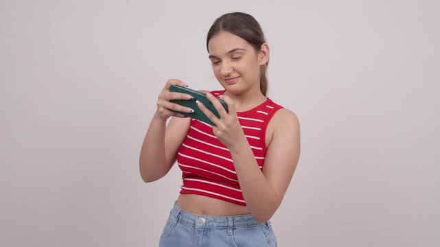 Happy Indian Teenage Girl Playing Game on Mobile Phone