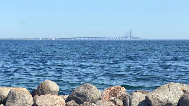 Footage from &Oslash;resund Bridge Zealand Denmark View From Land on Sunny Summer Day Static Handheld 4K Video Filmed from the Shore at Drag&oslash;r