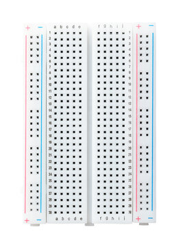 Solderless breadboard, universal prototyping perfboard isolated from above. Used to quickly build and test electronic circuits without any soldering. With power rails and labeled component rows. Photo