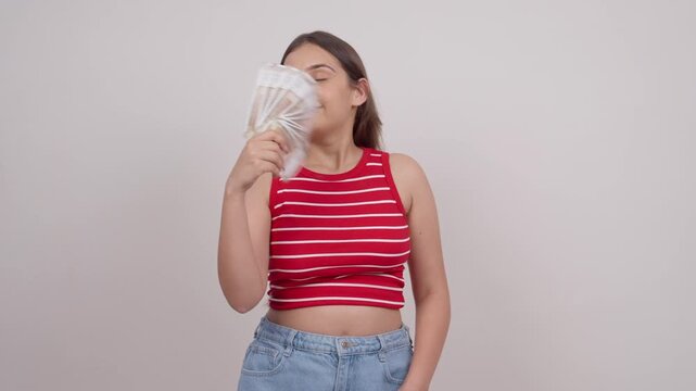 Indian Teenage Girl Using Money as Fan, Indian Rupees