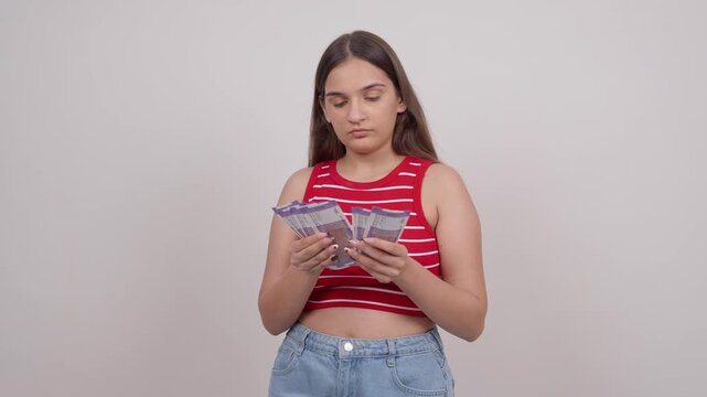 Indian Teenage Girl Counting 100 Indian Rupee Notes