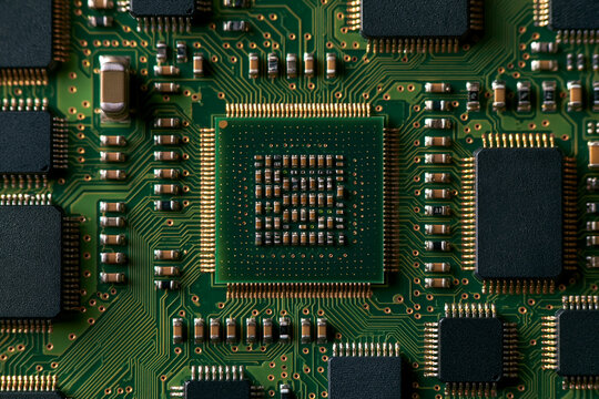 top down flat lay macro photograph of a green circuit board, silver solder joints and gold traces in razor sharp focus, ultra detailed technology background