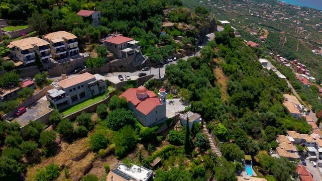 Drone View of Greek Orthodox Church and Hillside Homes Overlooking Messenian Gulf in Verga, Greece