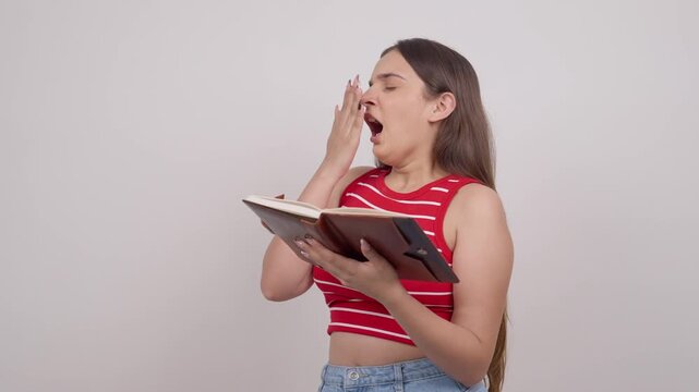 Indian Teenage Girl Reading and Yawning