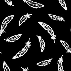 Obraz premium Hand-drawn grunge white fineliner seamless pattern of flying raven feathers on black background for gothic textiles, dark fantasy apparel, witchy stationery, horror wrapping paper, mystical home decor