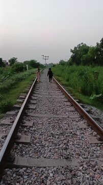 Children walking on railway track in the jungle
