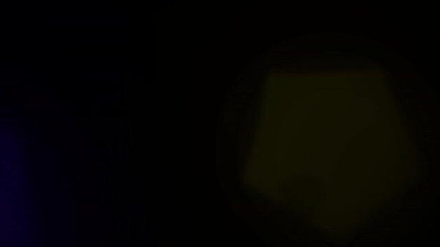 Abstract Pentagonal Bokeh Light Effects on Dark Background.