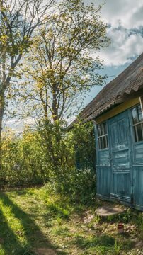 timelapse, time lapse, Old blue wooden house in a bright spring garden