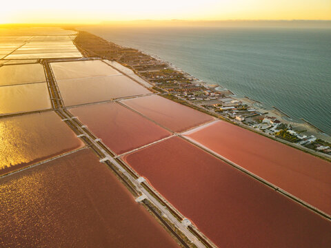 Aerial view of the Margherita di Savoia salt mines at sunset in Puglia, Italy