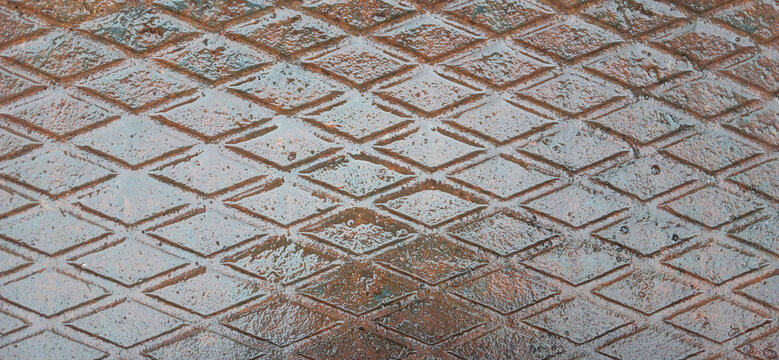 Rusty diamond plate metal texture with weathered green paint