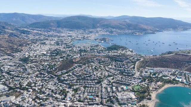 Aerial Video Bodrum beach with pier and seaside resort buildings Turkey