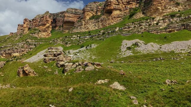 Woman standing on rocky outcrop in mountainous landscape