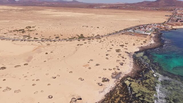 Aerial views of Corralejo town on the northeast coast of Fuerteventura, Canary Islands of Spain. It's known for Corralejo Natural Park, featuring windy, dune-backed beaches like Playa del Moro.