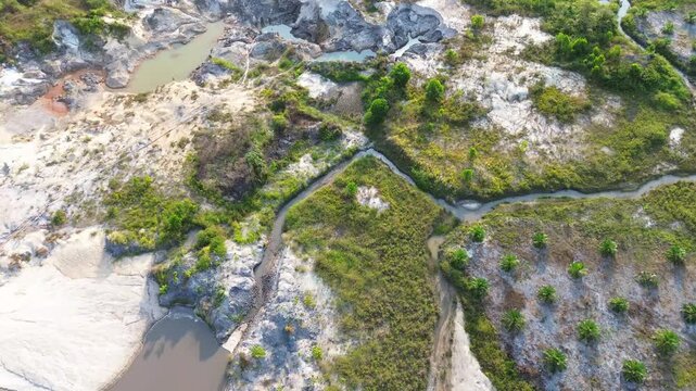 Aerial view of oil palm plantation adjacent to ex tin mining pit lake and natural rainforest in Bangka Indonesia
