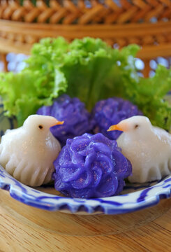 Traditional Thai savory snacks Chor Muang and Jeeb Nok, flower shaped and bird shaped dumplings on a plate