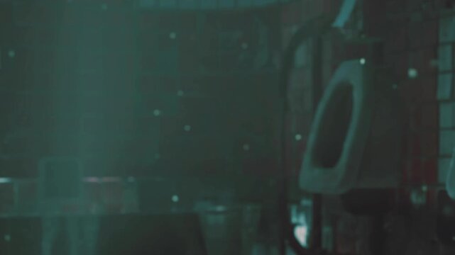 Light streams in through a window into a room filled with dust particles. The setting shows a sense of age with worn furniture and an overall quiet feel.