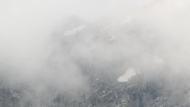 Time-lapse of clouds moving over rocky mountain peaks
